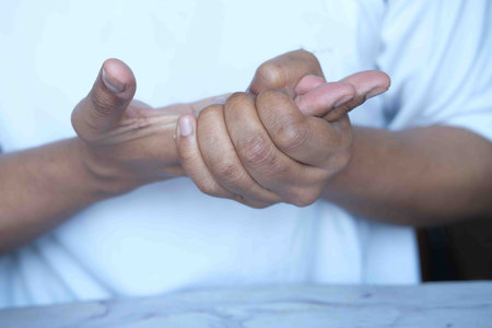man suffering pain in hand close up