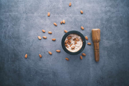 almond powder and almond in a jar on table,の写真素材