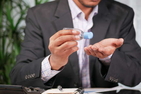 businessman using sanitizer gel on on office deskの写真素材
