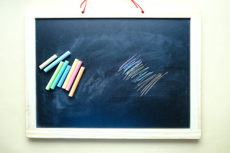 colorful chalk and chalkboard on black backgroundの写真素材