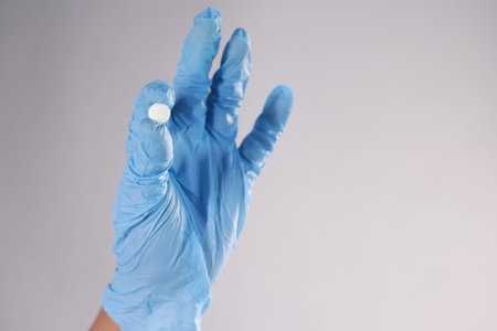 single medical pills on palm of hand , top view