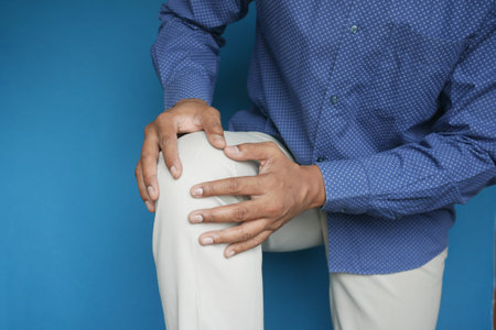 Close up on man suffering knee joint pain