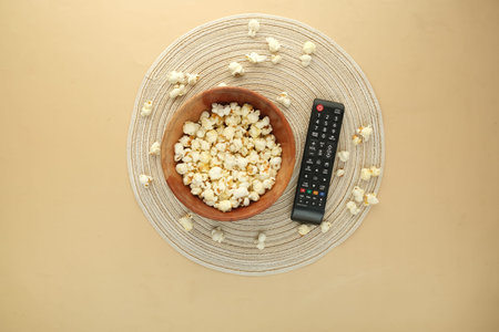 high angle view of popcorn and Tv remote on table