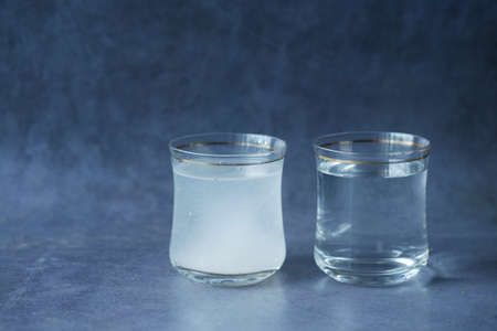 comparing dirty and clean eater on black backgroundの写真素材