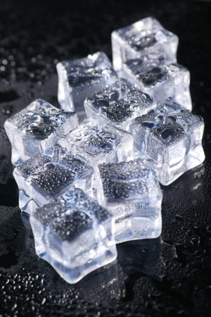 close up of many ice cubes on black background