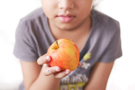 5 year child girl hand hold a appleの写真素材