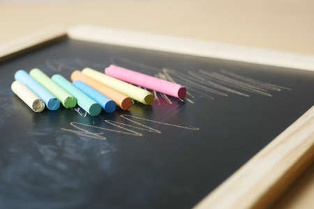 colorful chalk and chalkboard on black backgroundの写真素材