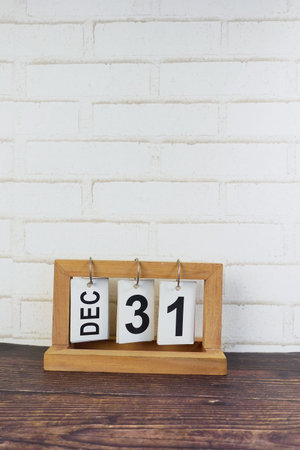 wooden calendar set on the 31 of December.