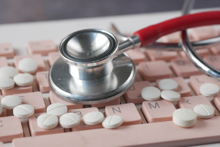 Close up of pills and stethoscope on keyboard
