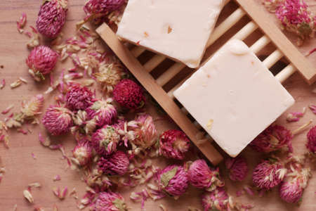 Homemade natural soap bar and dry flower on black backgroundの写真素材