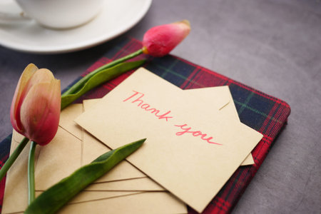 thank you message, envelope tulip flower on table