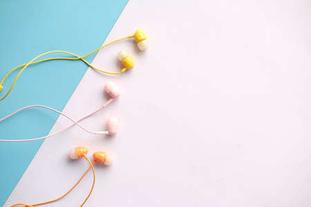 top view of colorful earphone on color backgroundの写真素材
