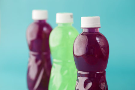plastic bottles of soft drink on table