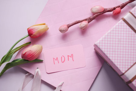 f mother day gift and flower on table.