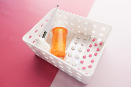 medical pill container, blister pack and thermometer in a plastic organizer