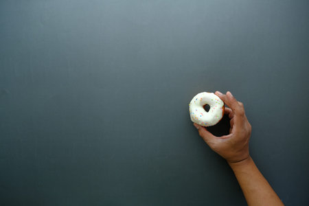 hand holding fresh donuts top view