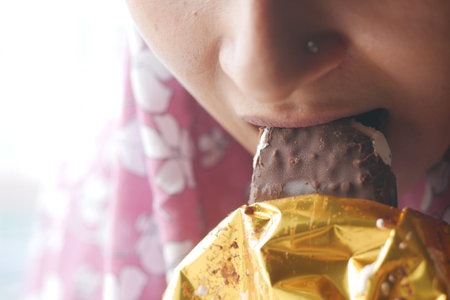 young women eating chocolate flavor ice cream