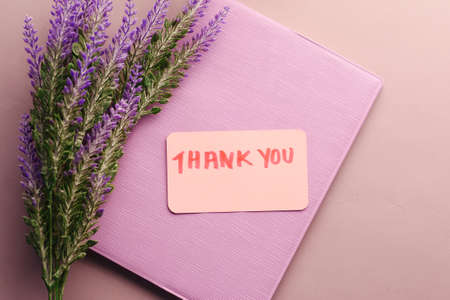 thank you message, notepad and lavender flower on tableの写真素材