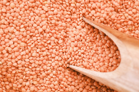 Bowl of uncooked dhal on white,