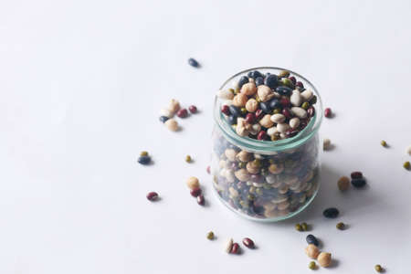 mixed beans in a glass jar on tableの写真素材