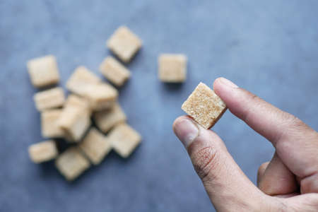 holding a brown sugar cube top viewの写真素材