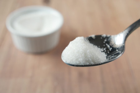 white sugar on a liver spoon close up