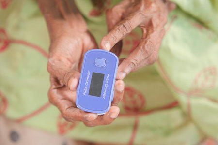 senior young women hand using pulse oximeter