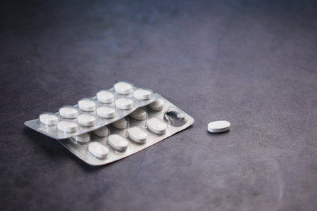 Close up of pills of blister pack on black background