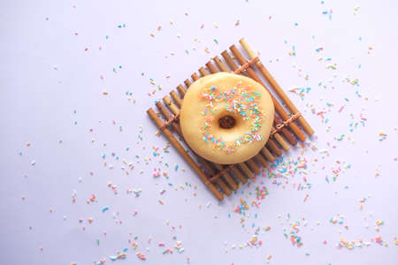 slow motion of dropping sprinkles on chocolate donutsの写真素材