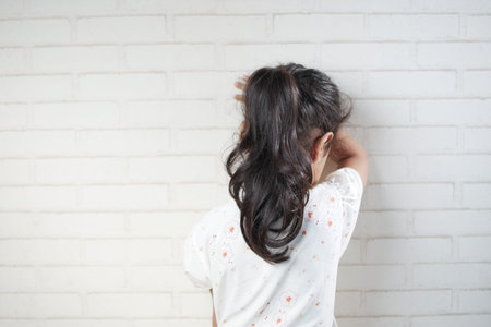 sad child child hiding her faceの写真素材