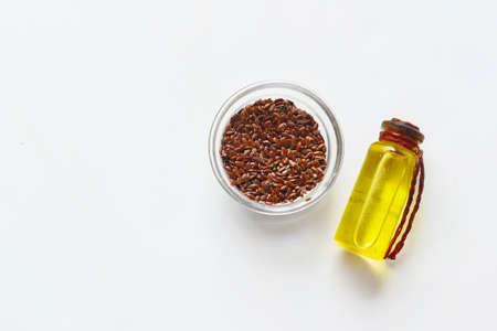 top view of flax seeds and oil on white backgroundの写真素材