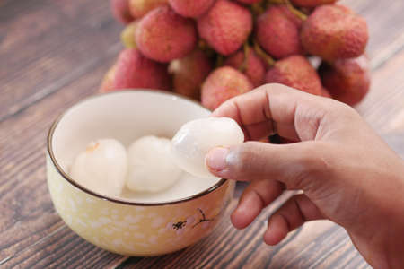 taking skin off from a Lychee fruitの写真素材