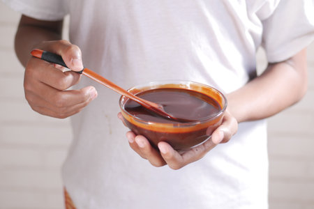 men holding a bowl of dark chocolate creamの写真素材
