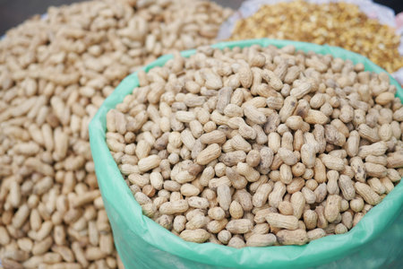 Processed pea nuts in a bowl on table top down .
