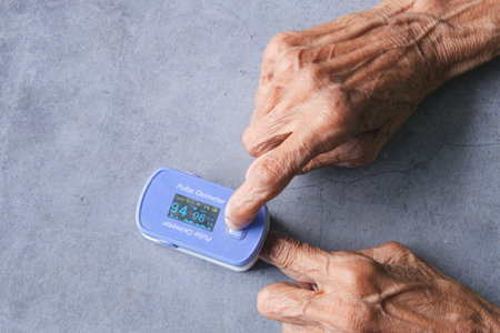 senior young women hand using pulse oximeter