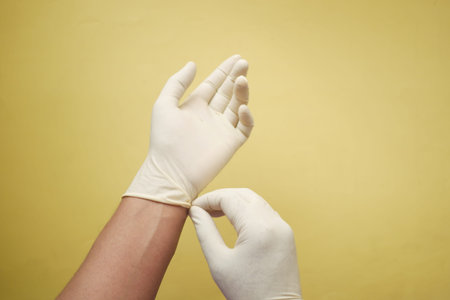 man doctor wears medical gloves, close up