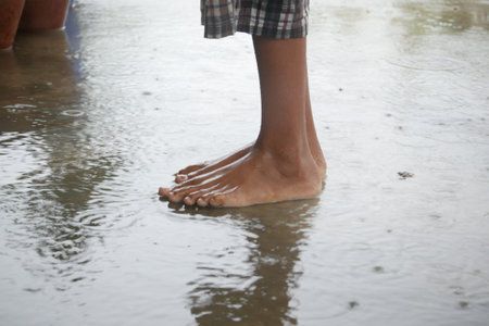 child jumping on water water after rain