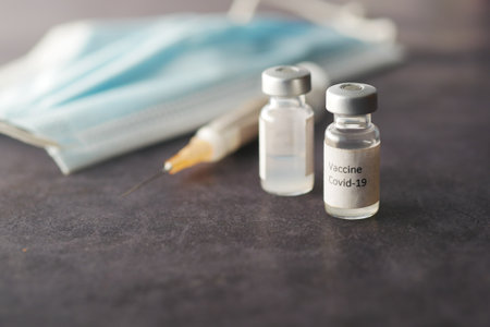 Close up of coronavirus vaccine and syringeの写真素材
