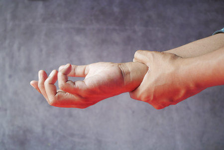 man suffering pain in hand close up