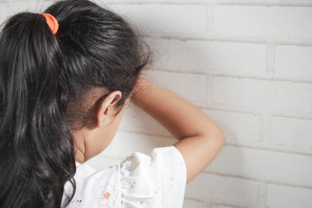 sad child child hiding her face