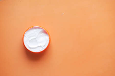 Close up of beauty cream in a orange containerの写真素材