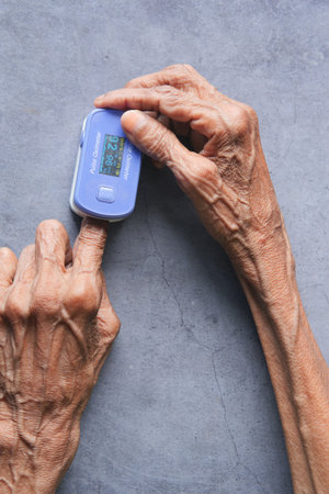senior young women hand using pulse oximeter
