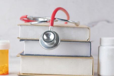 stethoscope on a stack of books on tableの写真素材