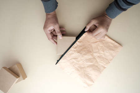 top view of person putting a gift box in a bagの写真素材