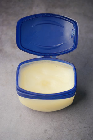 petroleum jelly in a container on black backgroundの写真素材