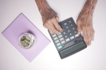senior women hand using calculator on deskの写真素材