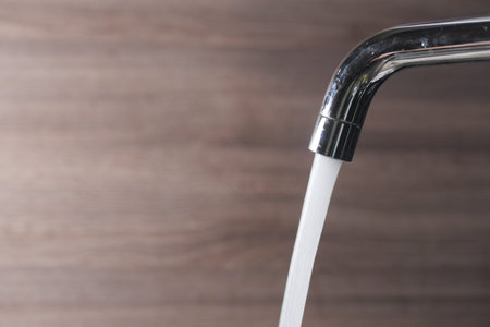 close up of faucet with flowing water