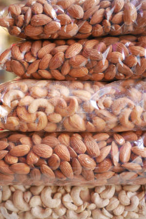 close up of almond and cashew nuts in a plastic packetの写真素材