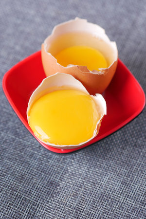 Group of broken brown raw eggs,