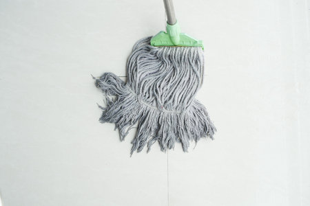 cleaning tiles floor with mop